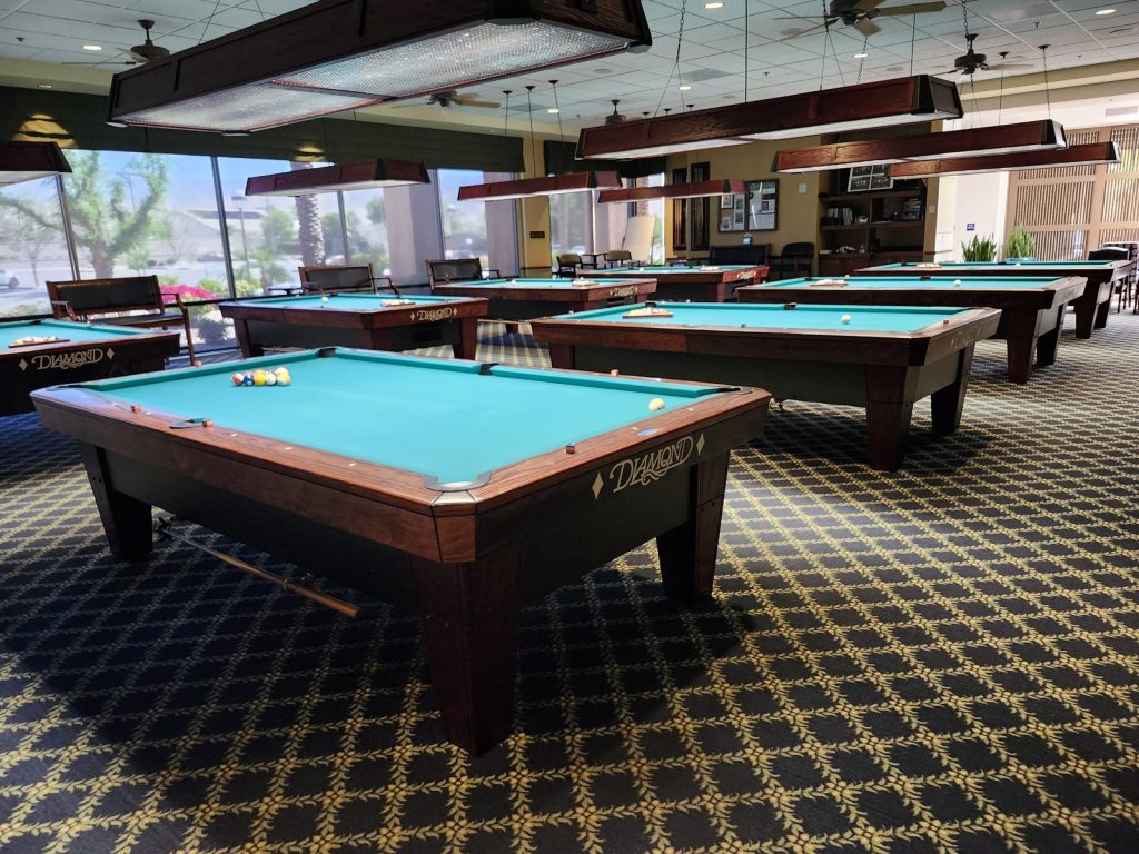 The club's billiards hall with rows of Diamond pool tables under overhead lights