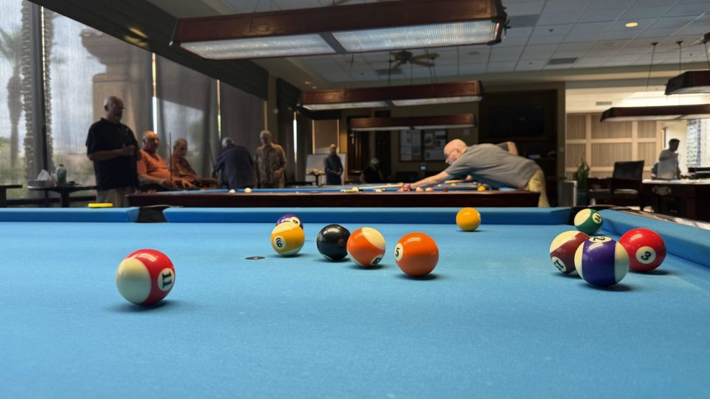 Billiard balls spread across the table during a game in progress