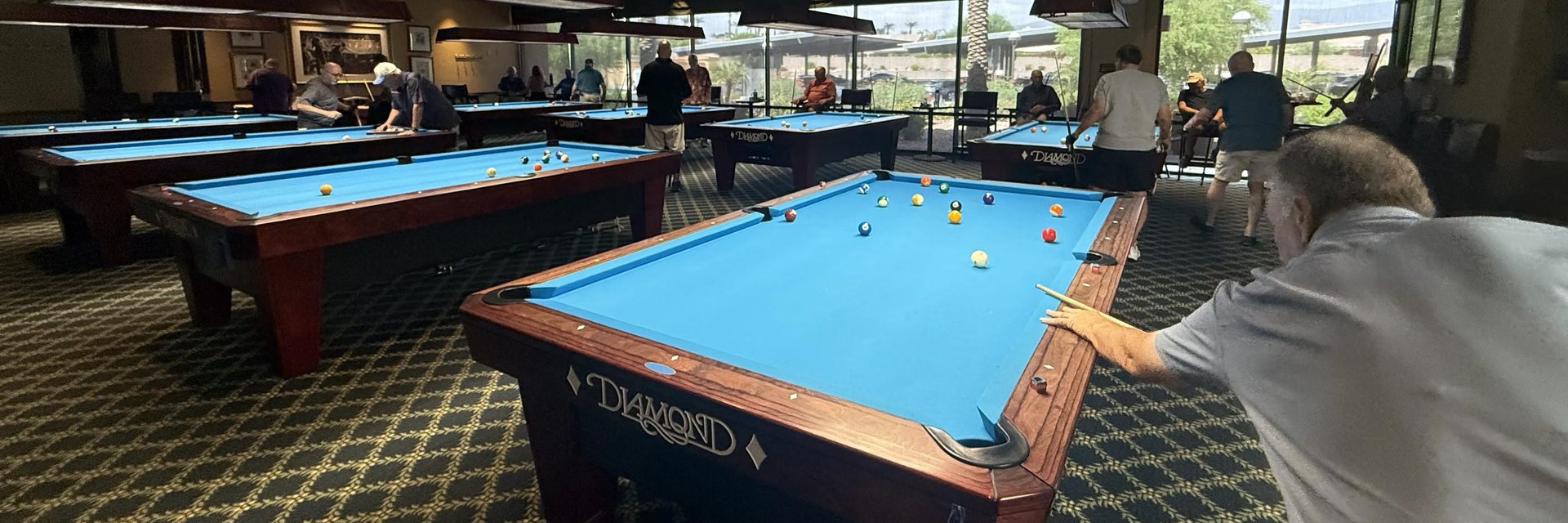 A member takes a shot during a busy afternoon in the club’s billiards hall