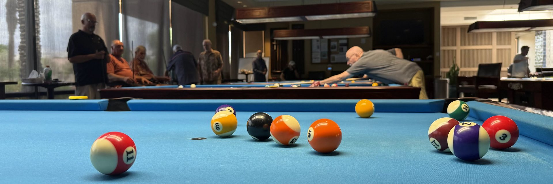 Close-up of billiard balls on the table during a game in the club hall